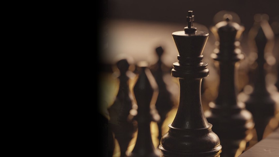 A dark chess king standing tall on the board