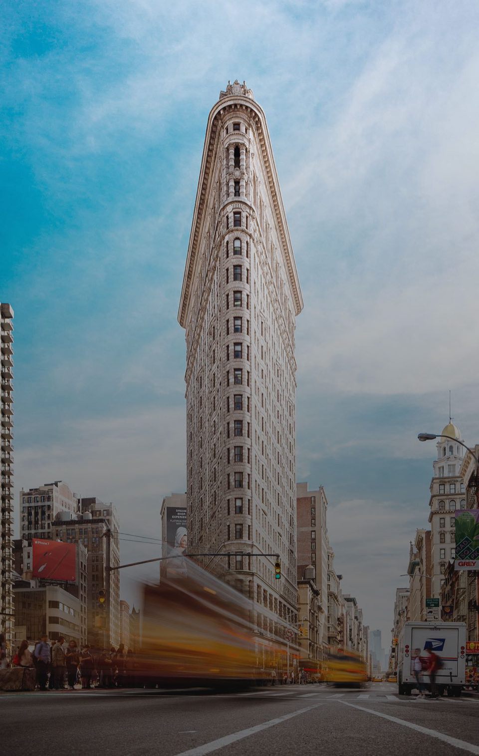 The Flatiron Building rising over Fifth Avenue traffic in New York