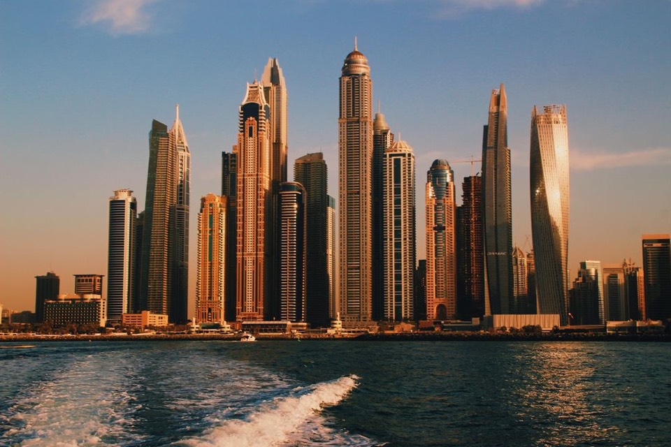 A skyline of towers at golden hour